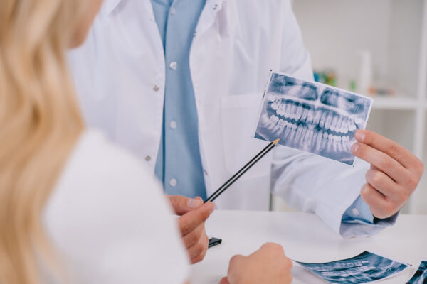 cropped-view-of-orthodontist-pointing-at-teeth-x-r-2022-12-16-16-55-57-utc (1)